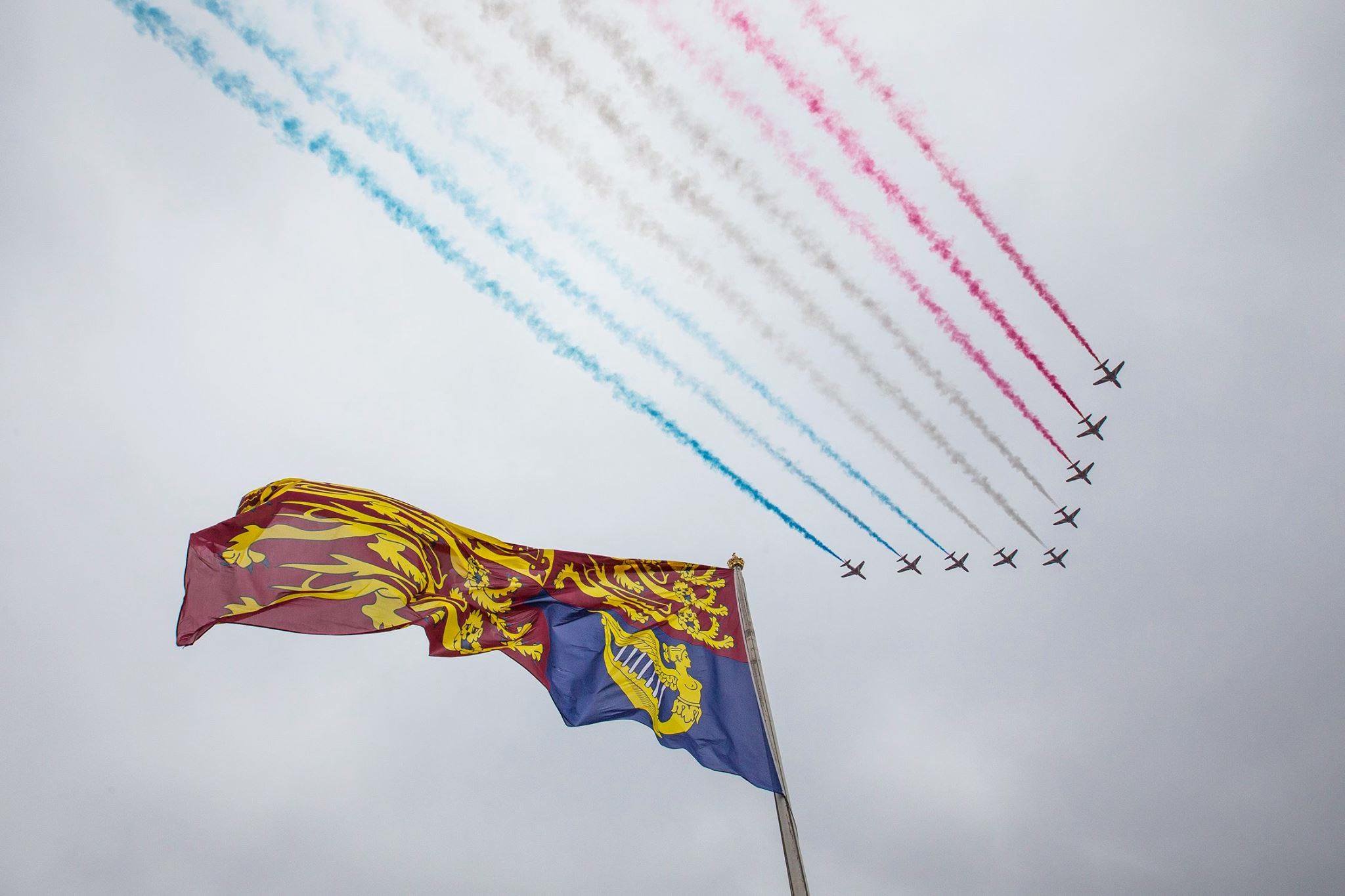 The Royal Standard of the United Kingdom flies under red, white, and blue flypast.
